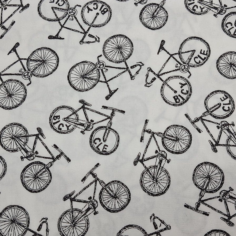 Tela de algodón tipo patchwork con fondo blanco, estampada con bicicletas negras