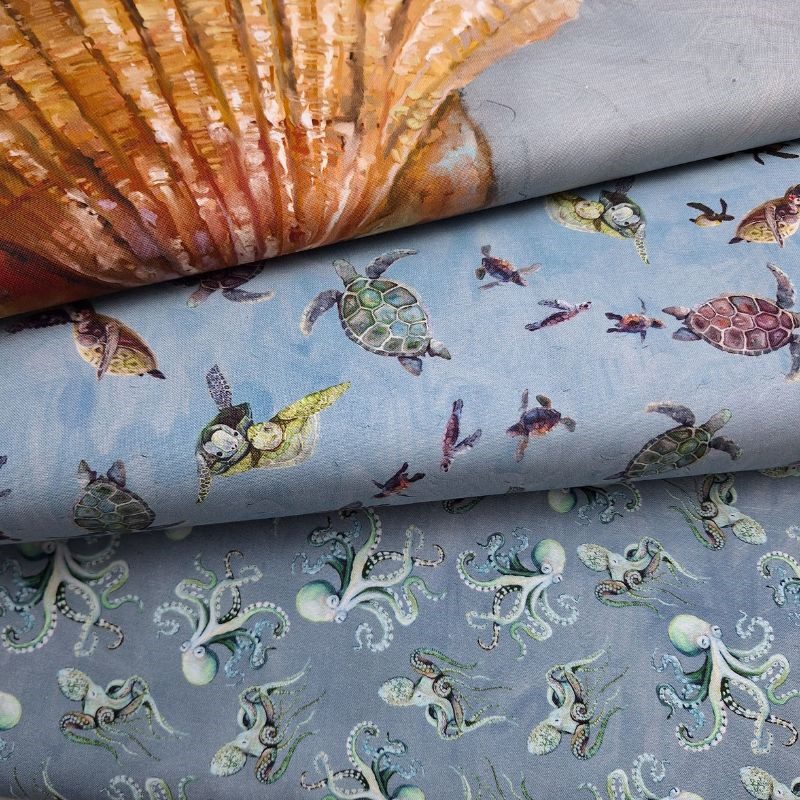 Telas de algodón de la colección A Drop in the Ocean de Studio E Fabrics con dibujos de animales marinos como tortugas y pulpos.